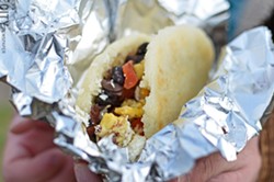 A breakfast arepa stuffed with black beans, egg, and goat cheese from Hello Arepa. - PHOTO BY MATT DETURCK