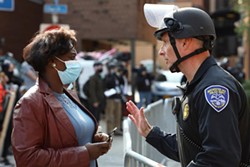 the Rev. Myra Brown of Spiritus Christi Church talks with Rochester Police Capt. Ray Dearcop - PHOTO BY MAX SCHULTE