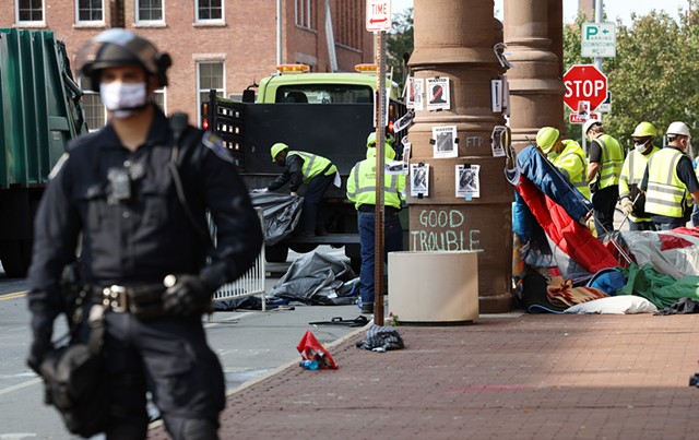 A city crew clears away tents that protesters set up in front of City Hall. - PHOTO BY MAX SCHULTE