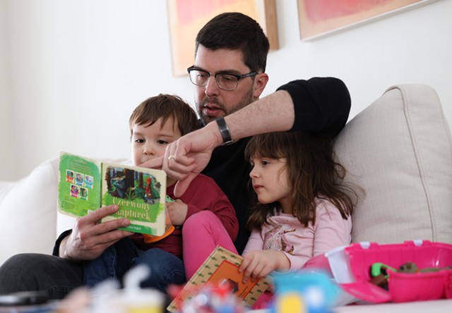 "I think we underestimate not just what kids can handle, but on what they pick up on and already know," says Justin Murphy, pictured reading to his children. - PHOTO BY MAX SCHULTE