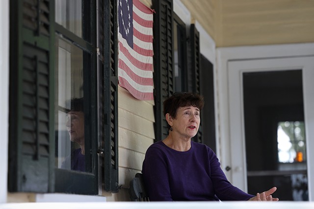 Lynn Barber on the porch of her historic home in Fairport in 2020. She said she was proud of her home's history, but called the language of the historic sign that stood out front from 1949 to 2020 "racist and offensive." - PHOTO BY MAX SCHULTE