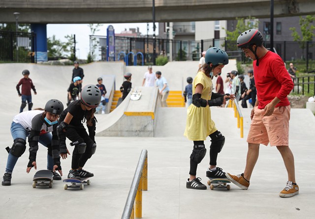 Sana and Sara, left, work on skating down a bank while Negah gets some help from Skateistan instructor Farzad Sharafi. - PHOTO BY MAX SCHULTE