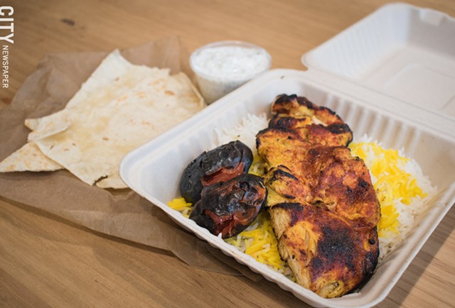 Chortke's spicy joojeh plate features grilled chicken and tomato over saffron basmati rice. - PHOTO BY JACOB WALSH