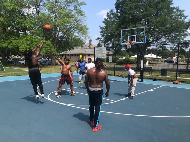 A pickup basketball game at Cobb's Hill Park on July 8, 2020, after the city replaced the rims it had taken down in March due to concerns about the spread of the novel coronavirus.
